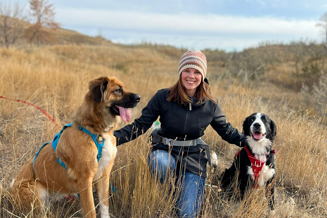 Administrative assistant Kim Gilbert is pictured with her two dogs.