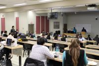 Group of residents attending the Core IM Research Day in a lecture theatre.