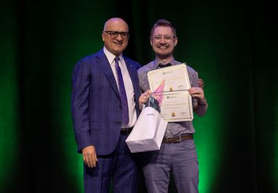 Dr. Kolbenson receives an award.