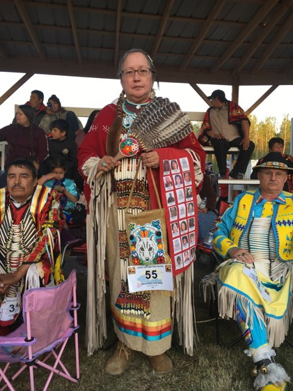 A dancer in traditional regalia at the Canoe Lake Pow Wow, raising awareness for MMIWG2S. 