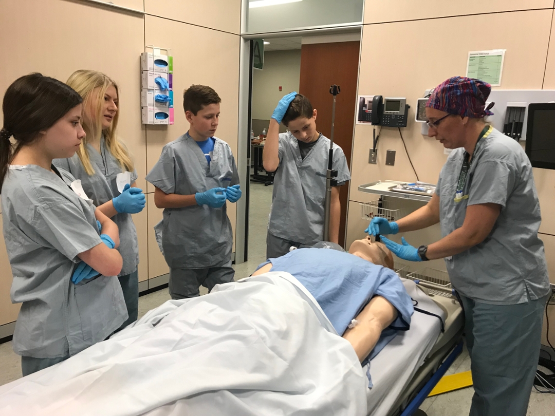 Anesthesiologist Dr. Justina Koshinsky, right, delivers instructions to a group of Grade 9 students. Photo by Kristen McEwen