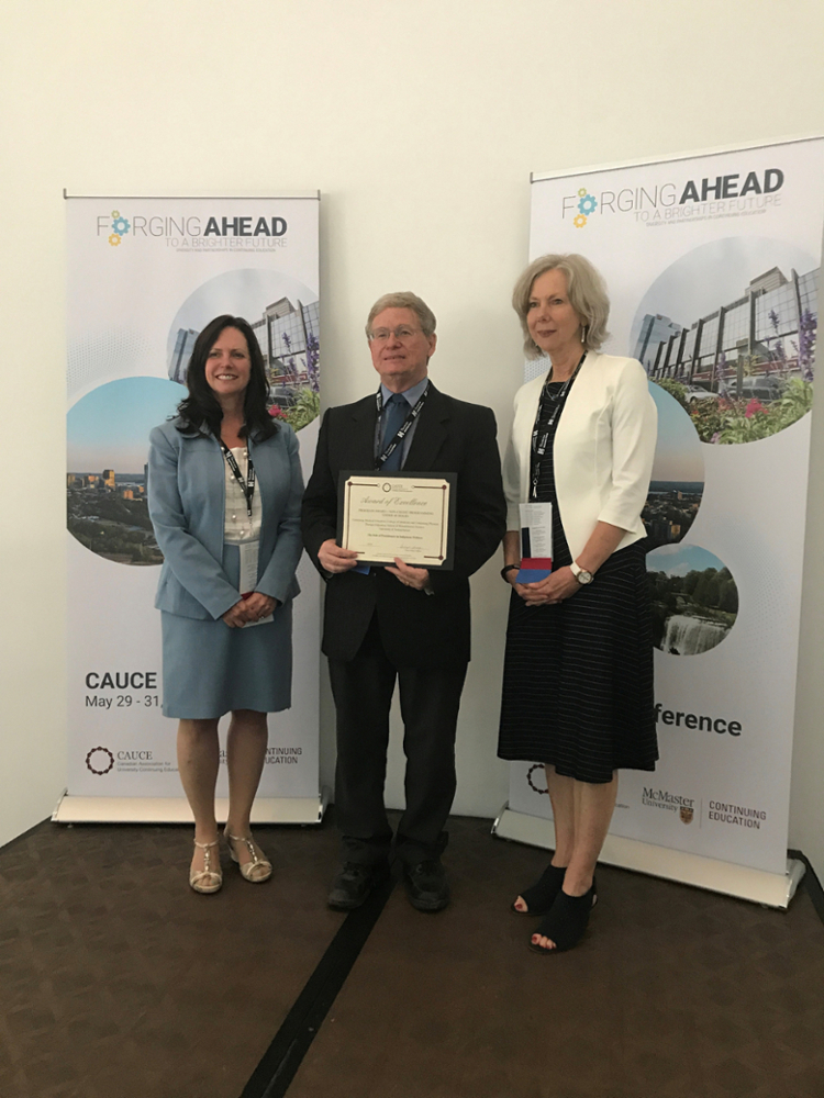 On behalf of the Indigenous Wellness program, Continuing Medical Education instructional designer Dan Mittleholtz, centre, accepts the Canadian Association for University Continuing Education (CAUCE) Program Award for Non-Credit Programming Under 48 Hours in Hamilton, Ont. on May 29.