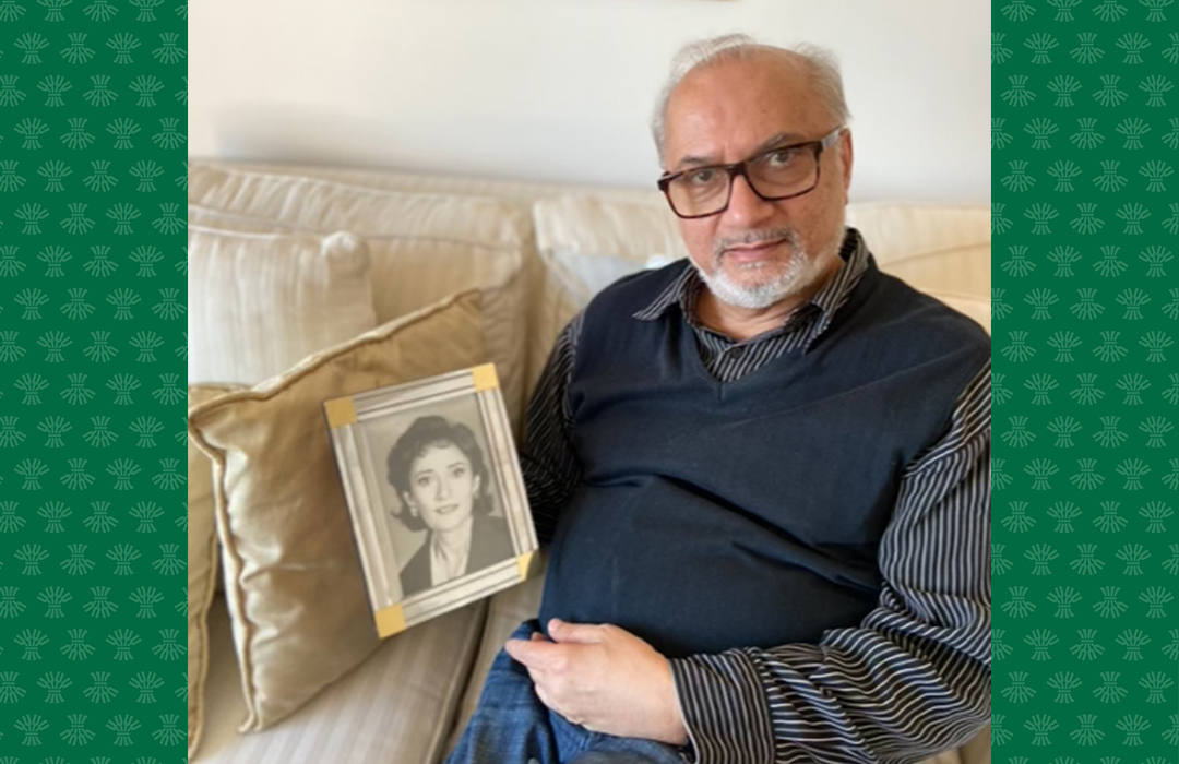 Physician Dr. Dan Dattani holds a photo of Chandra Dattani. 