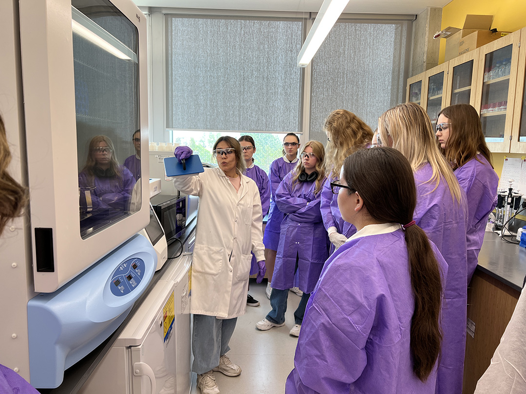 Dr. Atefeh Najafi (PhD) gives a tour of the Benson Cryobiology Lab to a group of high school students. (Photo: Royal University Hospital Foundation)