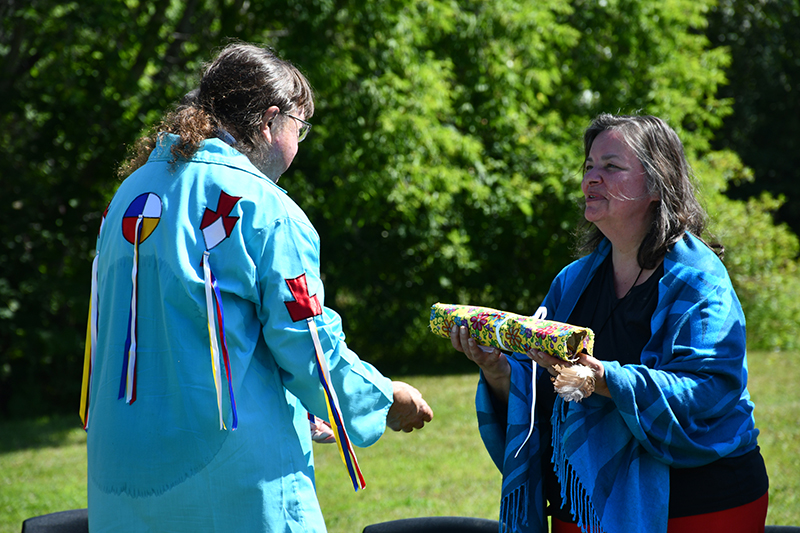 Malcolm King offering Sharon a gift following a partnership ceremony with Pewaseskwan, The Key First Nation and Yorkton Tribal Council in August 2022. (Photo: Submitted)