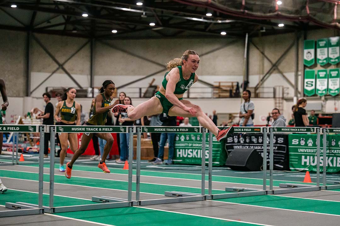 Nicole Ostertag competes in a hurdles event at the Saskatoon Field House. (Photo: Derek Elvin- Electric Umbrella)