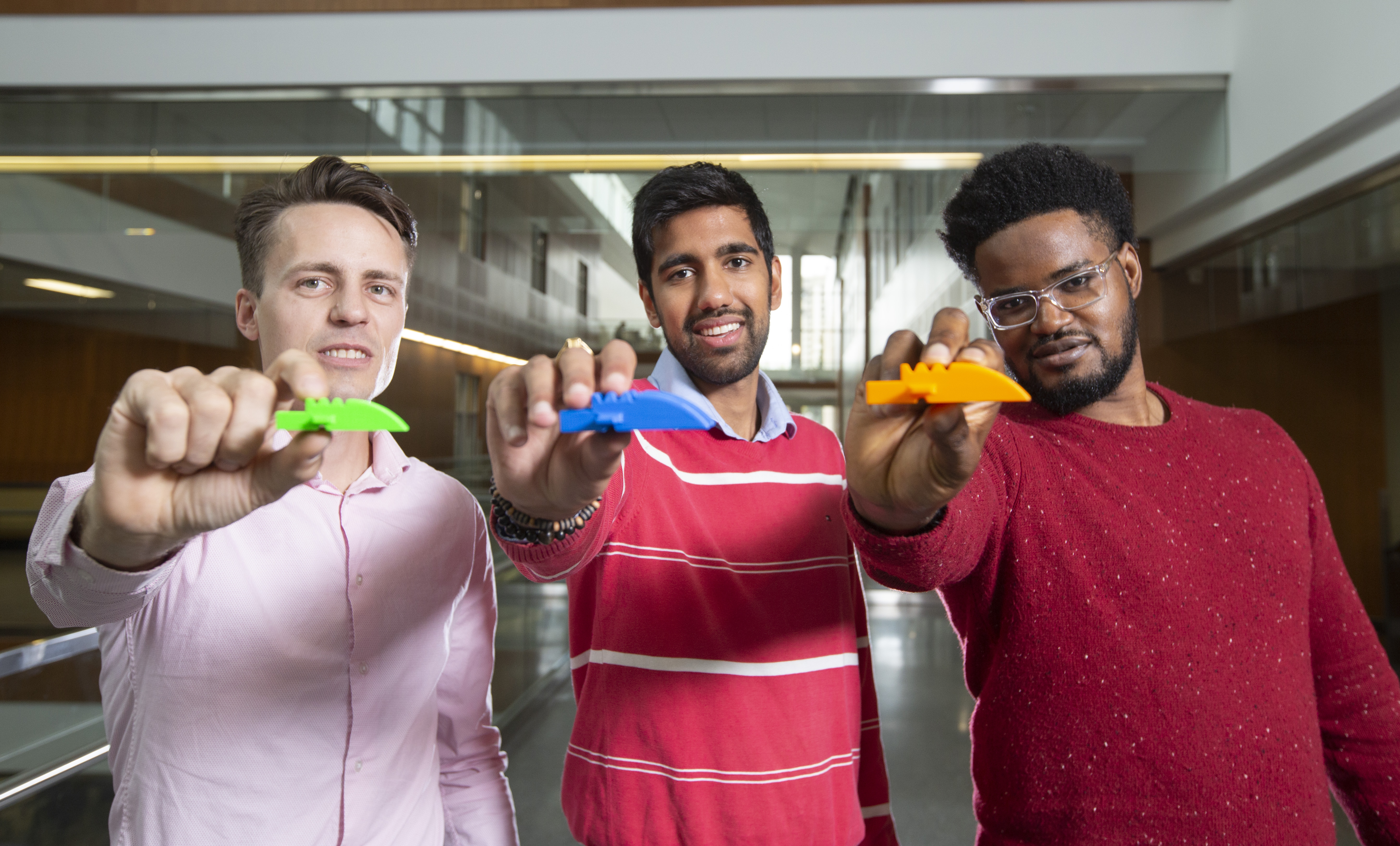 From the left: Soteria MedTech co-founders Cuylar Conly, Yash Shukla and Udoka Okpalauwaekwe hold a Lego-like airway device that could help save lives. Photo by Dave Stobbe